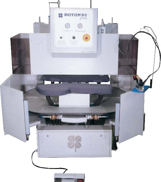 Rotondi 18RD P-17 180 degree rotation carousel for dart and side seam opening and pocket welt pressing. Equipped with Leonardo computer